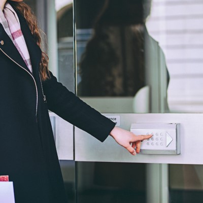 Girl entering code on keypad