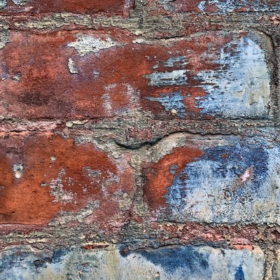 Close-up of red, white, and blue brick wall