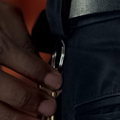 Hand reaching for key on CO's belt