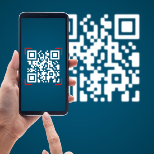 Hand holding a mobile device to scan a QR code 