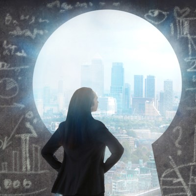 Woman looking at city through keyhole