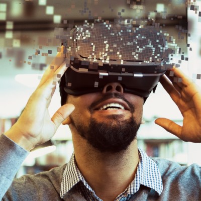Young male student using VR headset