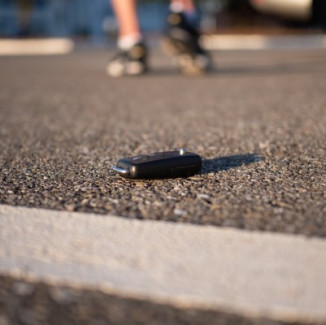 Man walking after losing a key in a parking lot