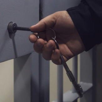 Hand unlocking jail cell