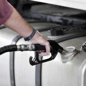 Man filling up the gas tank with gasoline 