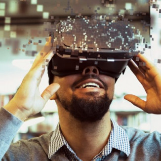 Young male student using VR headset