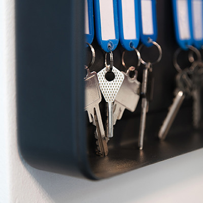Multiple sets of keys hanging on wall case
